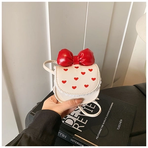 Detail of white PU mini crossbody bag with red heart embroidery and glossy bow decoration