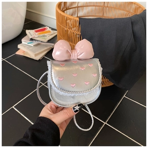 Detailed shot of silver PU mini bag with pink heart embroidery and a leather bow