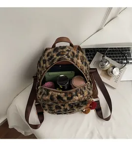 Interior view of leopard print plush backpack showing large capacity for tablet and accessories