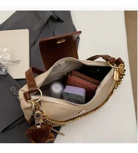 Interior view showing the spacious capacity of this cream and brown crossbody bag
