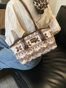 Brown and white floral faux fur shoulder bag with leather handles and brand logo