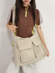 Quilted beige puffer tote bag with flap pockets shown as a casual crossbody on a model