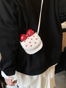 White mini shoulder bag with red bow and heart embroidery on lace trimmed leather