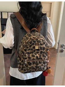 Fashion leopard print faux fur backpack with brown straps and plush pompom pendants