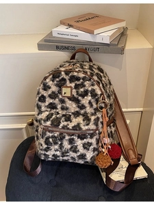 Fashionable leopard print plush backpack with faux fur material and leather straps