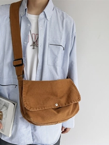 Classic brown canvas messenger bag with wide shoulder strap for casual daily use