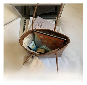 Interior view of brown leather bucket bag showing large capacity for tablet and items