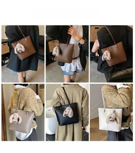 Litchi texture bucket bag with plush rabbit charm shown in multiple styling perspectives