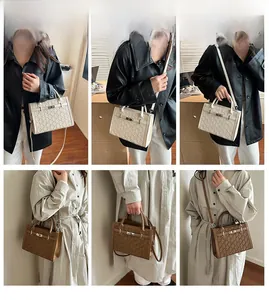 Detail view of stylish crossbody handbags with logo embossing and classic buckle lock design