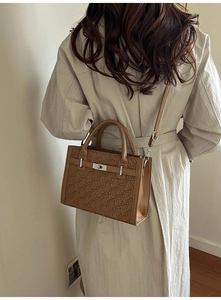 Rear view of a model wearing a brown crossbody Kelly bag with geometric textures