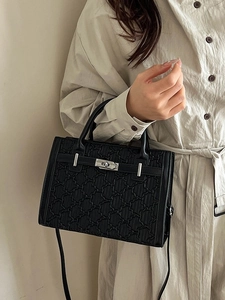 Classic black quilted leather handbag with silver lock and adjustable shoulder strap