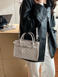 Beige embossed Kelly-style tote handbag for women featuring silver turn-lock and crossbody strap