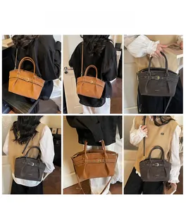 Detail showing brown and grey pleated leather handbags with adjustable straps and metal buckles