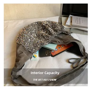 Interior view of spacious sequined grey handbag showing storage for phone and notepad