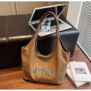 Detailed view of canvas tote bag with GTYLF embroidery and leather handles for work