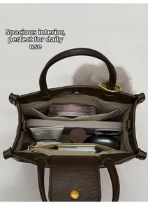 Top view of deep brown leather bag showing spacious interior with multi-pocket organizer