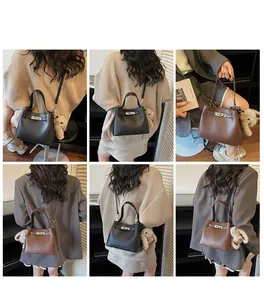 Detailed views of litchi grain leather bucket bags with plush charms in black and brown