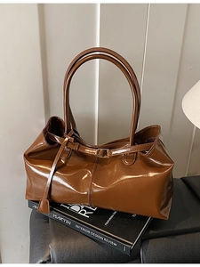 Retro dark brown glossy patent leather shoulder bag with dual handles and buckle detail