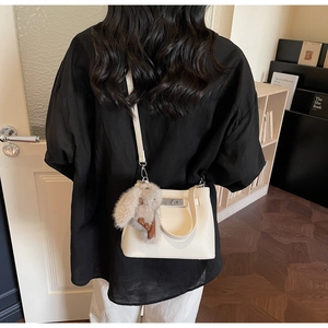 White lychee leather bucket bag with silver metal lock and cute plush rabbit accessory