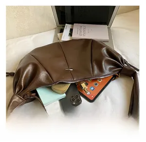 Detail view of large dark brown hobo bag interior showing spacious capacity for daily items