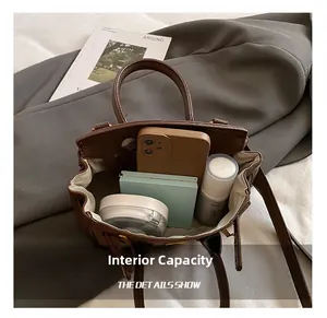 Internal capacity of brown pebble leather handbag showing daily essentials and storage space