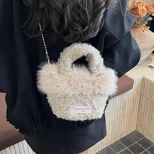 Detail of plush crossbody bag with furry trim and 'keep your spirit free' label