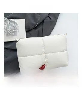 Macro shot of white quilted bubble pouch showing premium puffy texture and crossbody detail