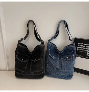 Detail of denim tote bags showing utilitarian front pockets and durable stitching craft