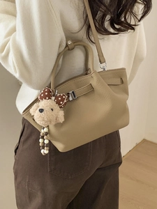 Chic light brown leather bucket bag with cute plush puppy charm for women's daily fashion
