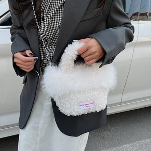 Detail of white plush faux fur handbag with silver bead chain and spirit free label