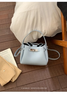 Détail du sac à main en cuir bleu clair à motif litchi avec fermoir tournant en métal iconique