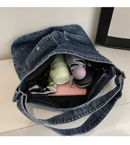 Detailed interior of large denim tote bag showing spacious storage with personal items