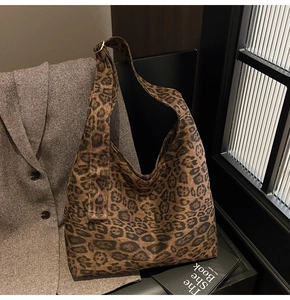 Detailed close-up of brown leopard print pattern and suede texture on large tote bag