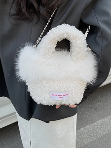 White fuzzy plush handbag with silver chain and keep your spirit free slogan on fabric