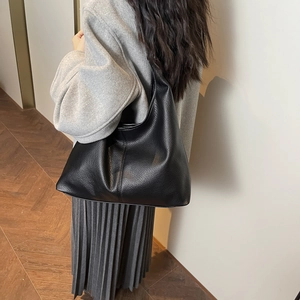 Detail showing the pebbled leather texture and spacious design of the black Hobo shoulder bag