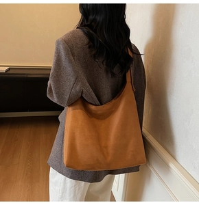 Brown faux suede tote bag shown on model for a stylish large capacity commute look