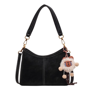 Vintage black crossbody bucket bag with contrast stitching and plush white charm