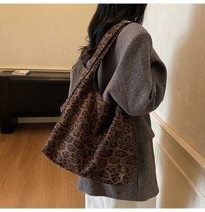 Close-up of high-capacity leopard print tote bag on shoulder with autumn wool coat