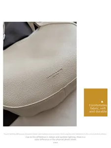 Detail of soft beige leather tote bag with lychee grain texture and minimalist branding