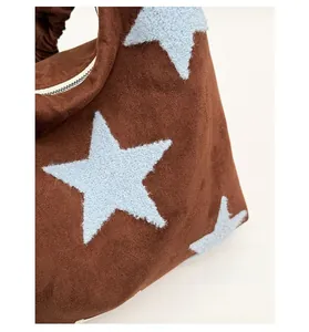 Detail of scratch-resistant brown star-patterned tote bag with custom durable fabric