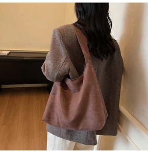 Brown faux suede hobo bag shown on shoulder, highlighting large capacity and soft texture