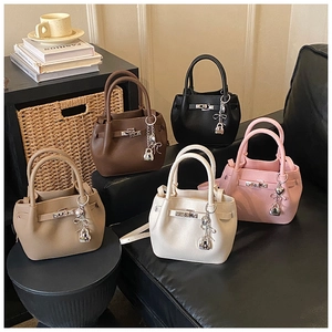 Détail de cinq sacs seaux colorés avec texture cuir litchi et pendentif cadenas en cœur