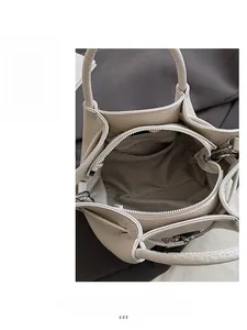 Interior detail of bucket bag showing smooth metal zipper closure and textured lining