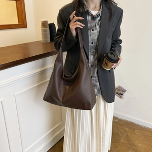 Detail view of the deep coffee pebbled leather hobo bag with a soft slouchy texture