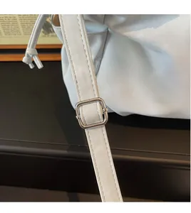 Detail of adjustable shoulder strap with silver buckle on soft leather tote bag