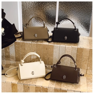 Litchi pattern leather handbags in four colors with decorative knotted handles and silver hardware