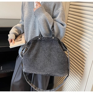 Detail view of large dark grey washed denim tote bag with adjustable shoulder strap