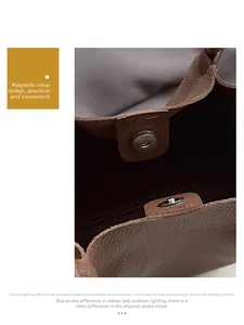 Detail view of the magnetic buckle closure on a brown pebble leather tote bag
