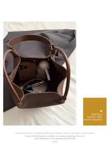 Top view of brown lychee grain leather bucket bag showing spacious interior with essentials
