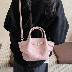 Vue détaillée d'un sac seau rose en cuir grainé avec boucle en métal argenté